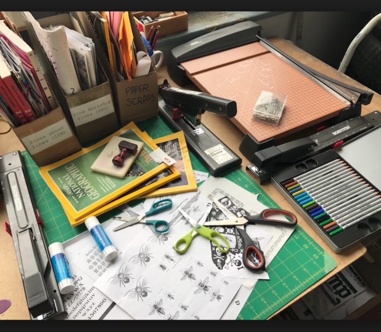 a collection of zinemaking supplies on a table