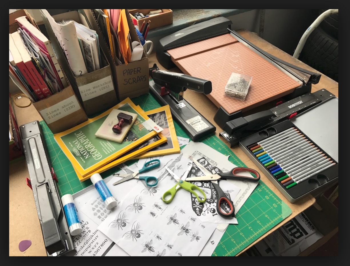 a collection of zinemaking supplies on a table