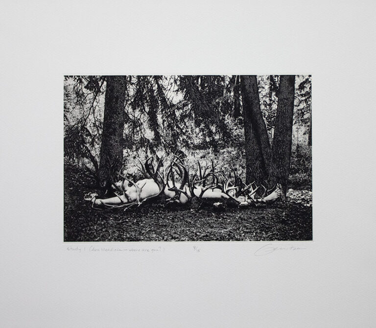 Study 1 Ana Mendieta Where Are You: a black and white print depicting a nude person lying on the ground in a wooded area, on top of a row of deer antlers.