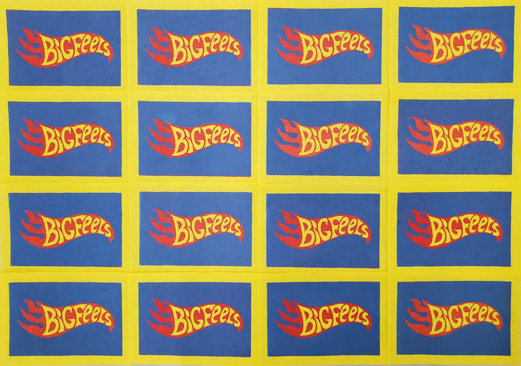 This image depicts a grid of identical prints on yellow paper. Each print features a blue rectangle containing a stylized red flame. The flame is emblazoned with yellow text that reads “Big Feels”. The overall design of the prints is strongly reminiscent of the Hot Wheels logo.
